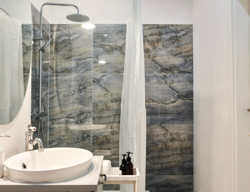 A Modern Bathroom Featuring a Sleek Marble Shower and an Elegant Overall Design Aesthetic